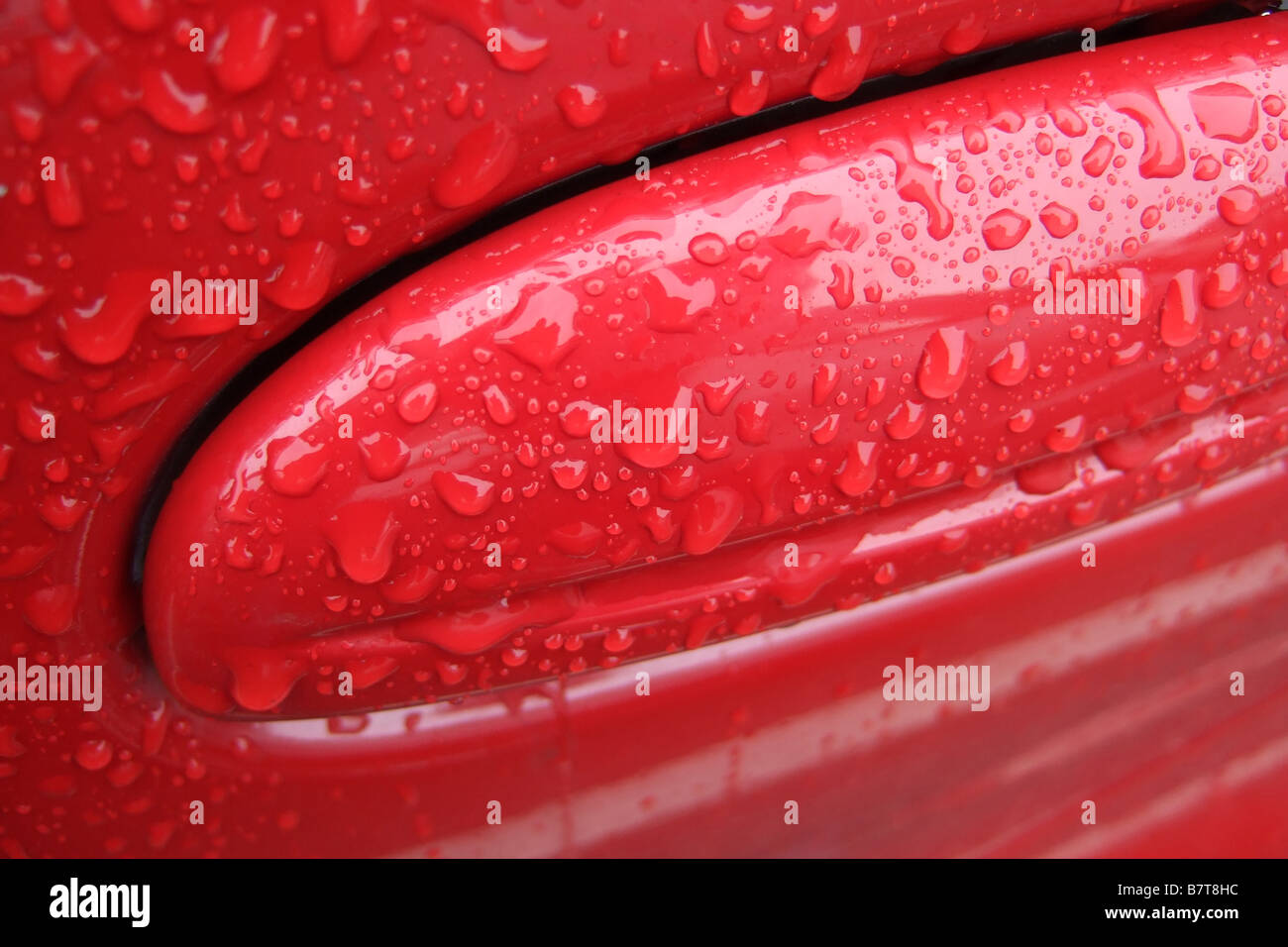 Raindrops on red car paint Stock Photo