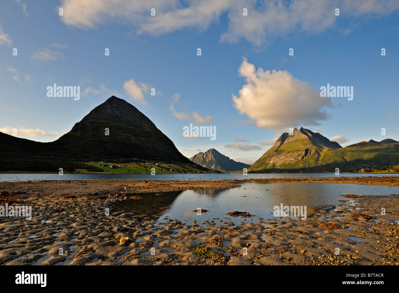 The island of Aldra with the Hjartinden peaks from the shore at Haugland north west Norway Stock Photo