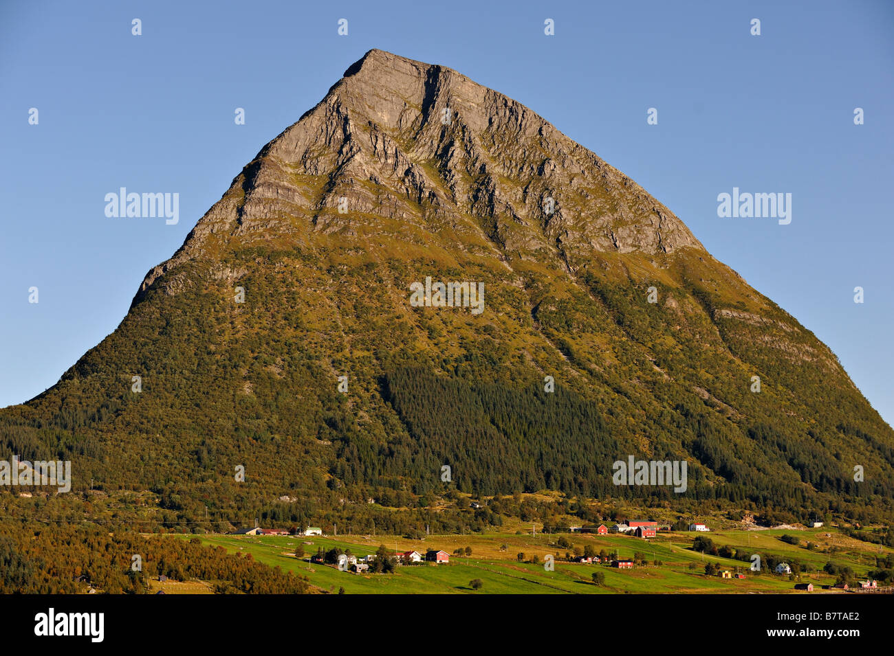 The island and village of Aldra with the Hjarttinden mountain from Haugland north west Norway Stock Photo