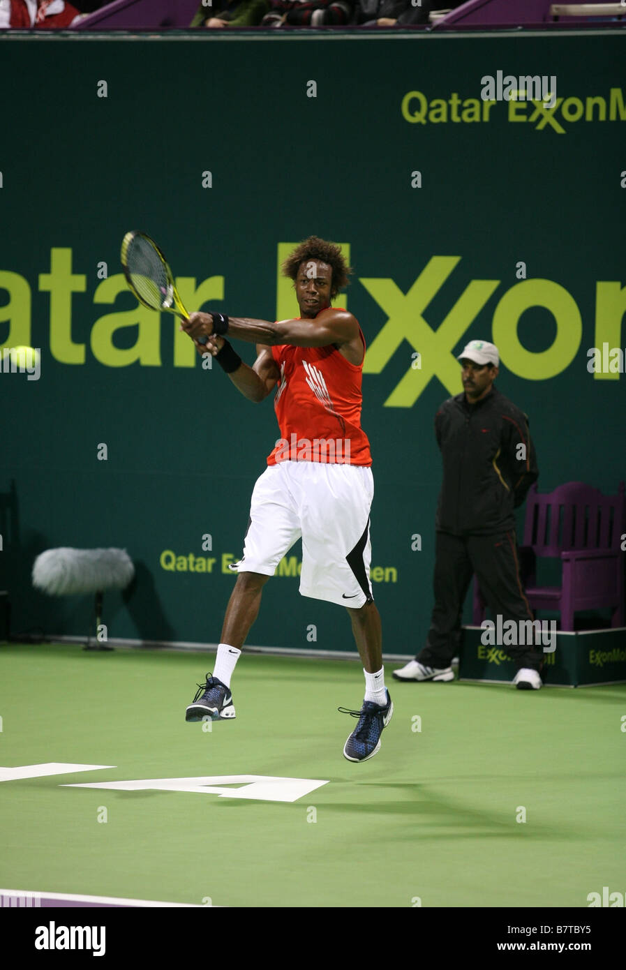Gael Monfils delivers a double handed backhand to return the ball left during his victory over world No 1 Rafael Nadal in Qatar Stock Photo