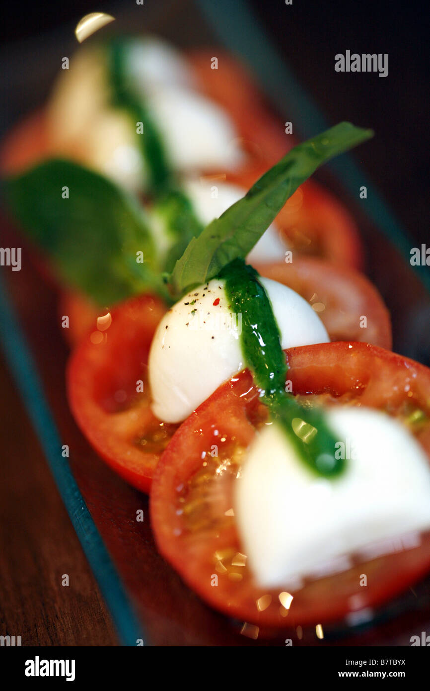 Mozzarella and tomato salad with pesto dressing Stock Photo Alamy