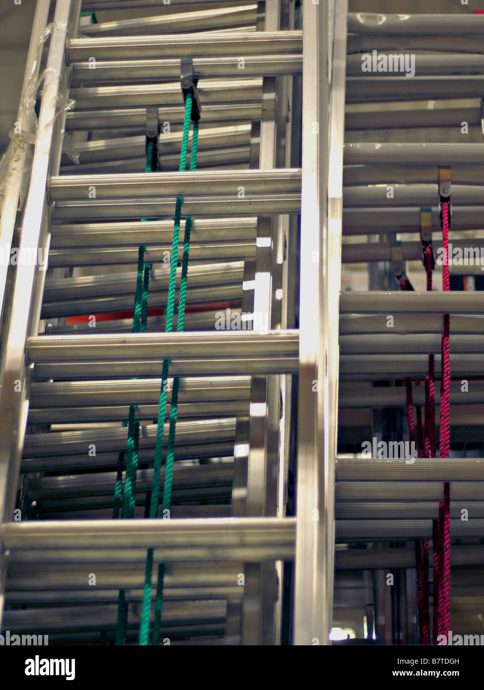 Aluminum ladders on display for sale at an industrial supply warehouse. Stock Photo