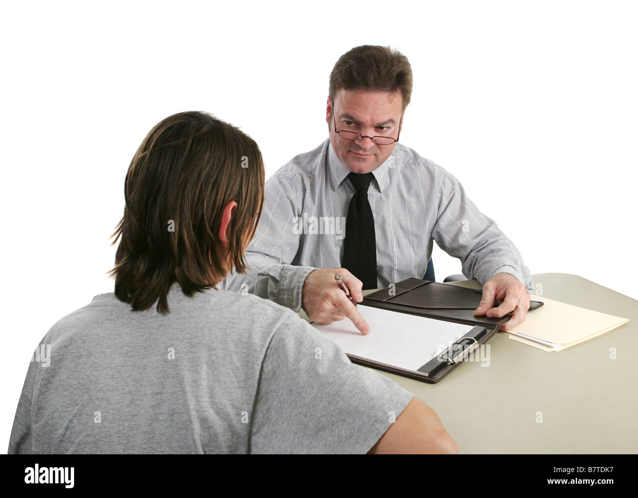 A guidance counselor sternly pointing to a student s permanent record Stock Photo