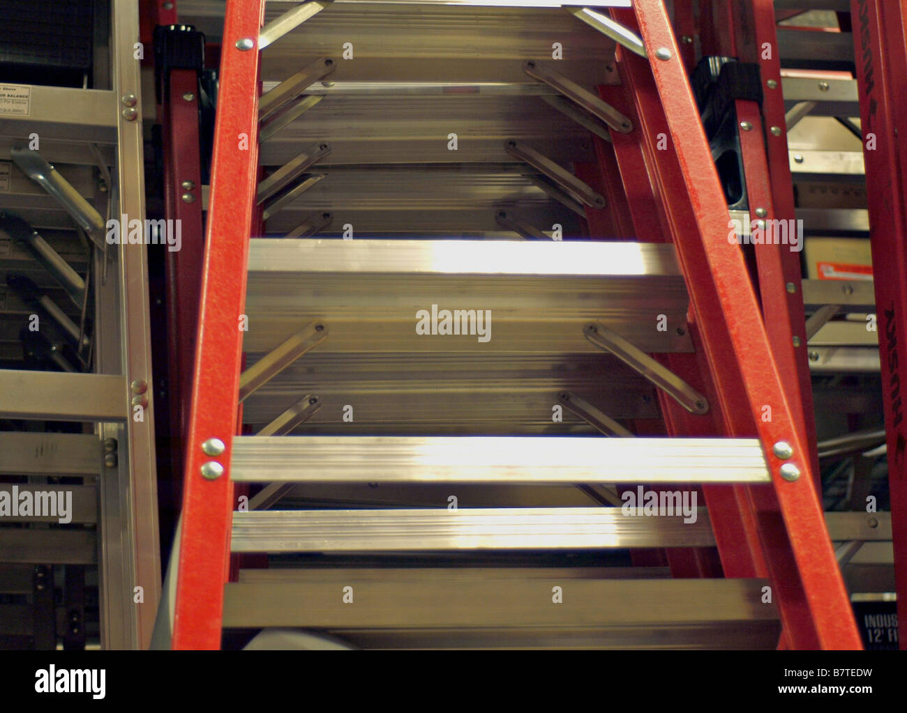 Aluminum ladders on display for sale at an industrial supply warehouse
