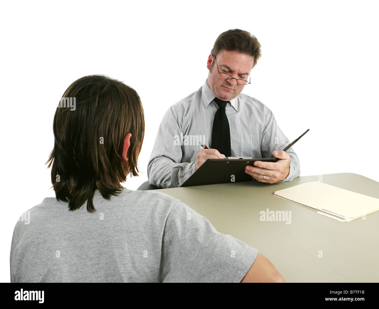 A guidance counselor interviewing a teen and taking notes Stock Photo