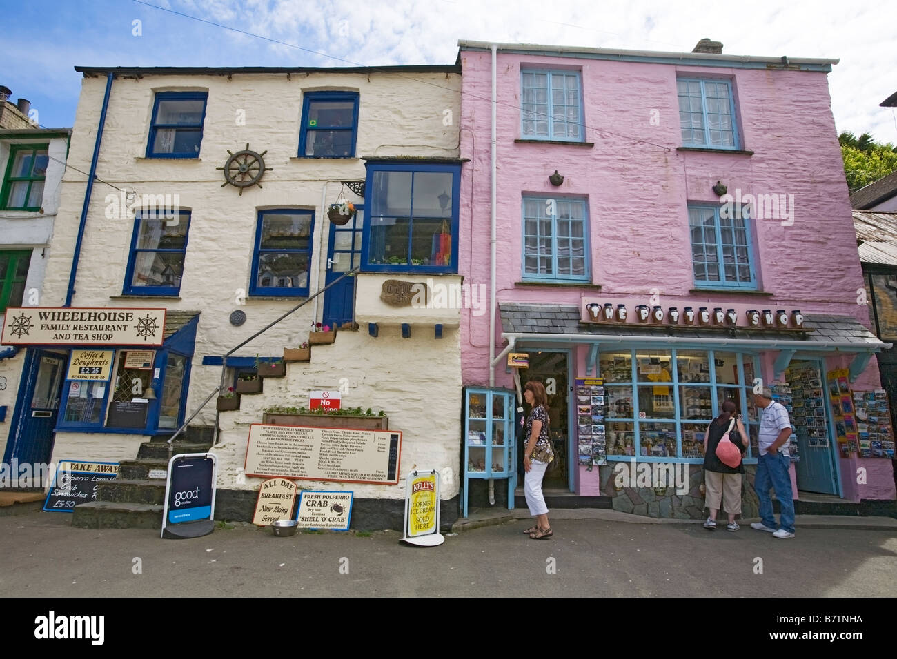Wheelhouse family restaurant and tea shop next to pottery shop, local businesses in Polperro, Cornwall, UK Stock Photo