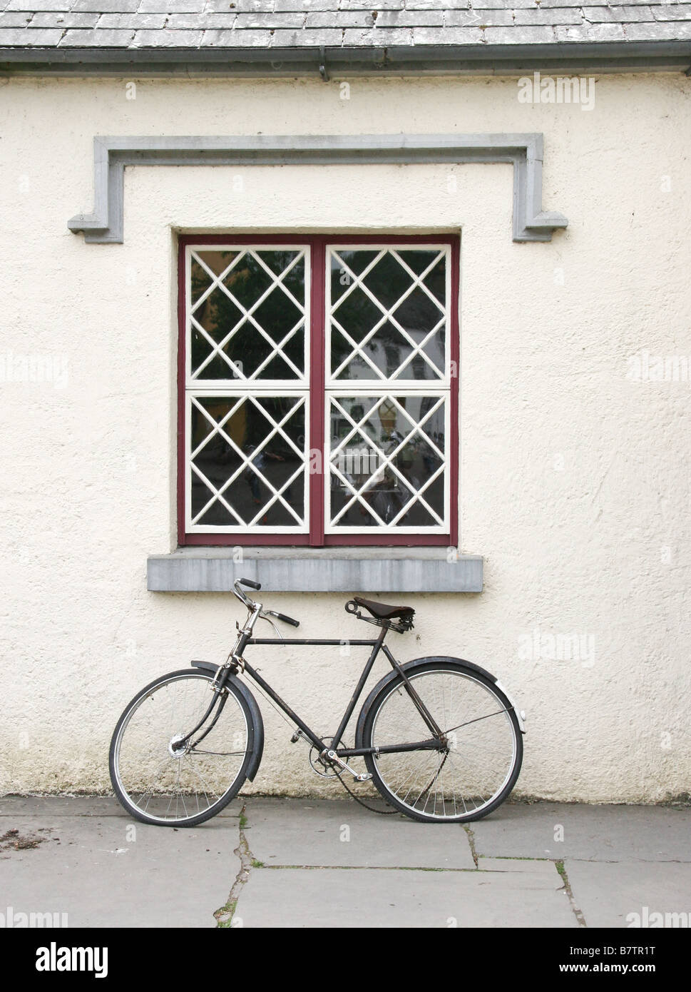 Bicycle in front of window at schoolhouse at Bunratty Folk Park, County Clare, Ireland Stock Photo