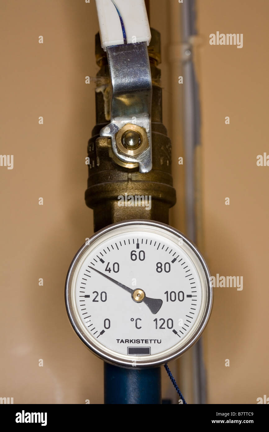 thermometer on central heating pipe Stock Photo Alamy