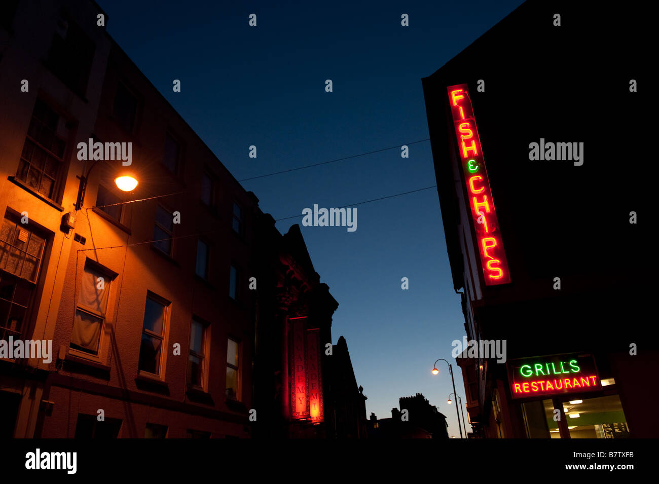 Fish and chips shop neon signs illuminated at night Aberystwyth Wales
