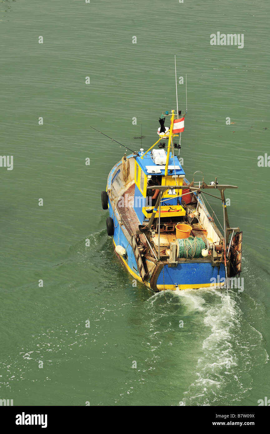 A small fishing boat returning to harbour Stock Photo - Alamy