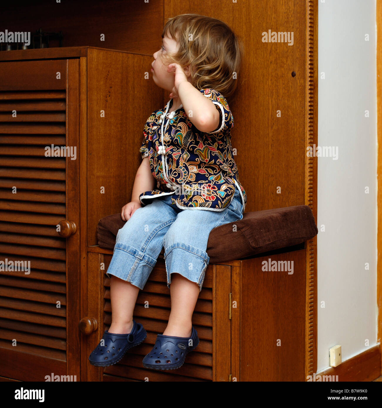 Two year old girl having a tantram sitting on naughty chair Stock Photo
