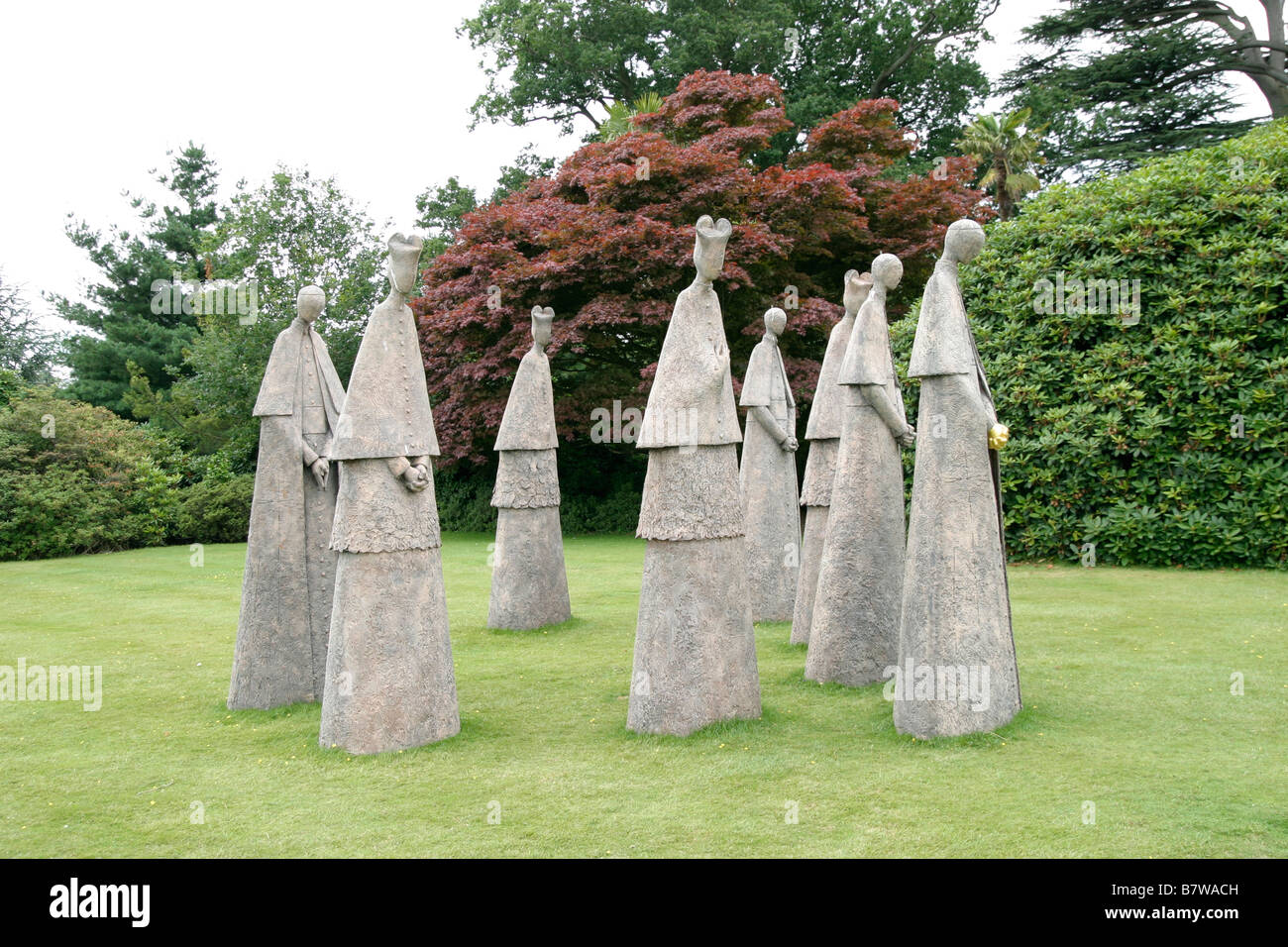 Eight bronze cardinals in Leonardslee gardens Stock Photo