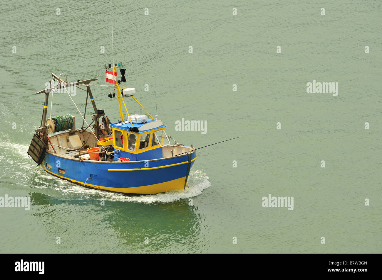 A small fishing boat returning to harbour Stock Photo - Alamy