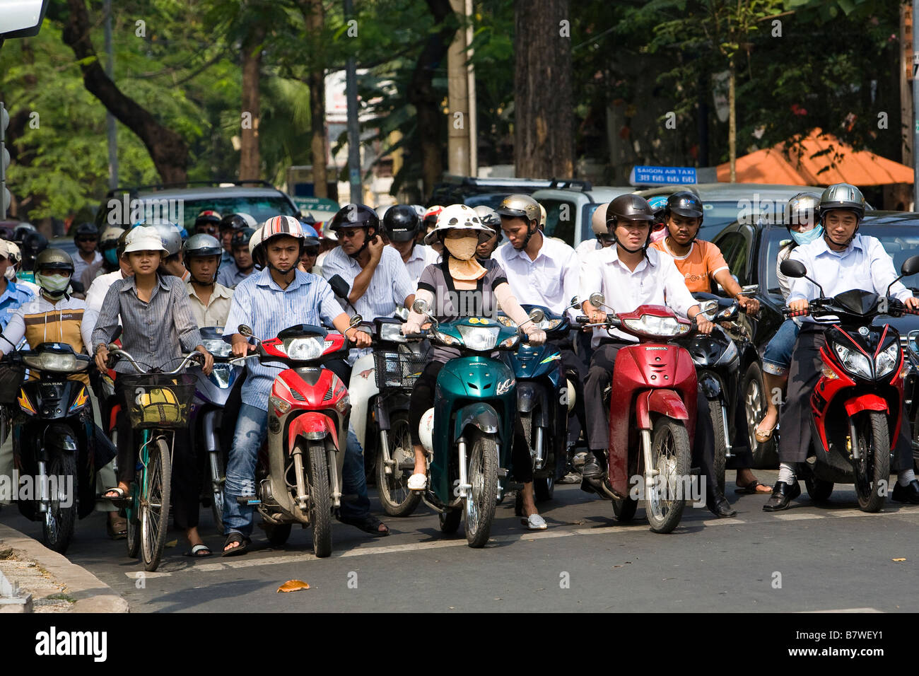 line up of people on mopeds Stock Photo Alamy