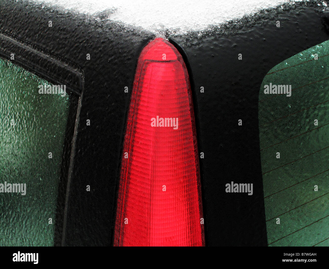 Abstract view of snow covered car and brake light. Stock Photo
