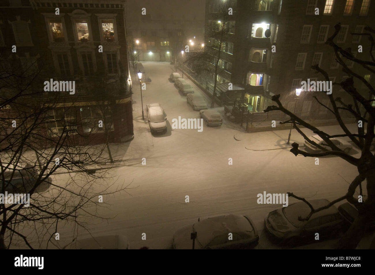 London street scene in snow at night Stock Photo