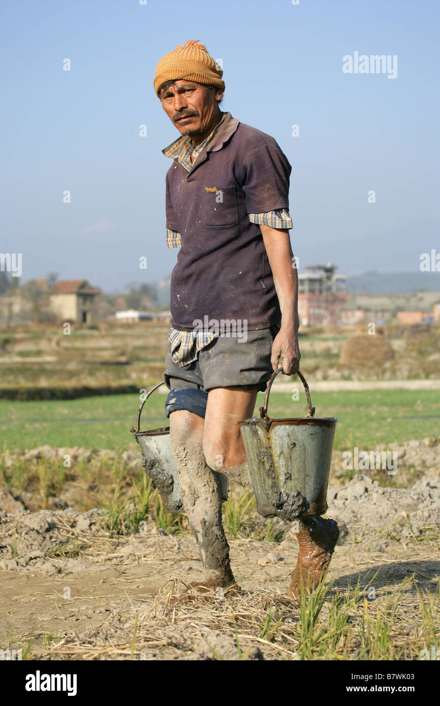 Man Carrying Two Buckets Stock Photo Alamy