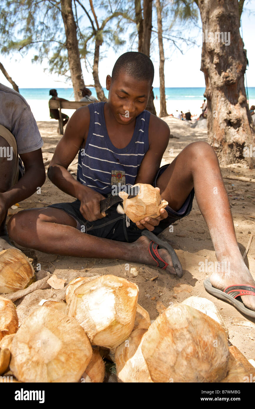African boy chopping coconuts in the town of Tofo in southern Mozambique Stock Photo Alamy