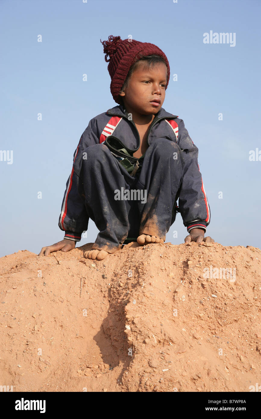 Boy sitting on sand Stock Photo - Alamy