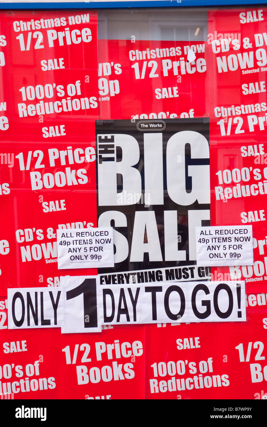 Book Sale advert in window of shop store selling half price cheap books