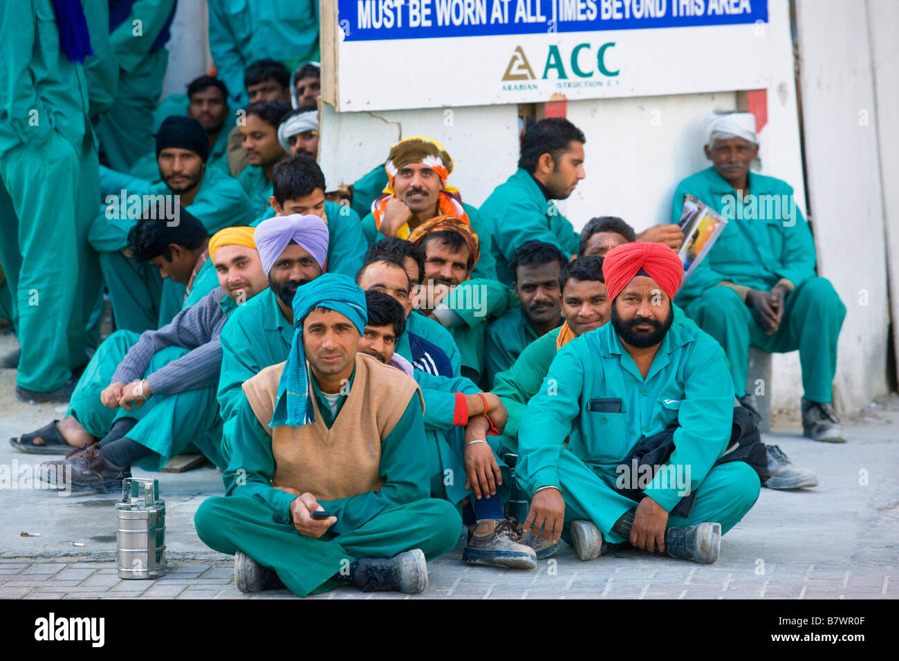 Construction workers waiting for their week s wages at Dubai Stock Photo