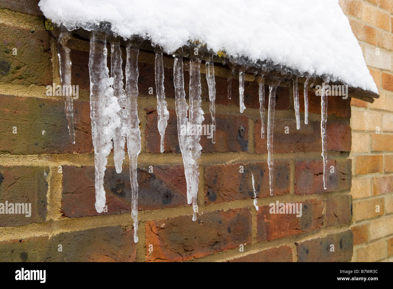 Icicles on side of house. Stock Photo