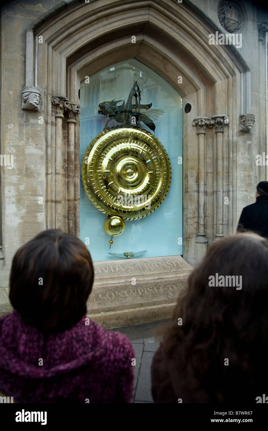 People admire & watch the time eating clock, created by Dr John Taylor