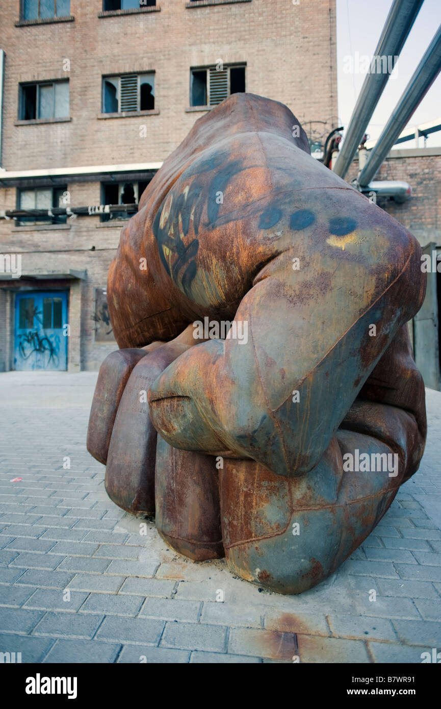 Modern art sculpture of fist on display outdoors at 798 Factory Art ...