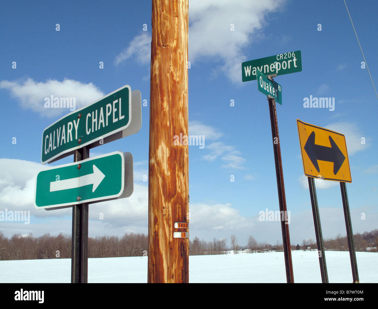 Rural intersection with various signs. Stock Photo