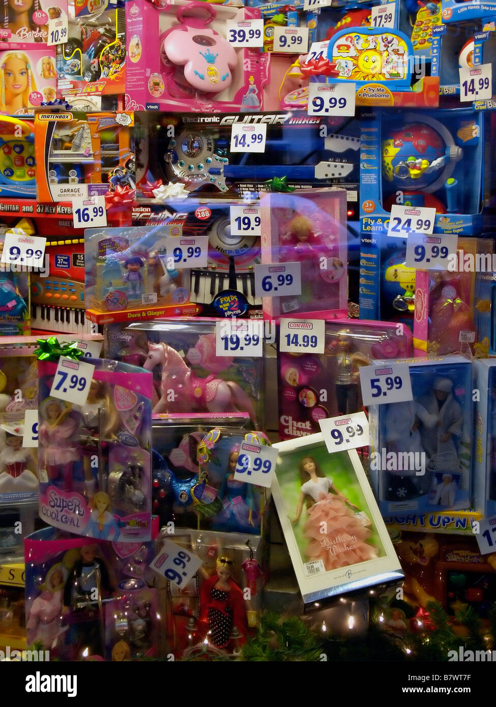 An unruly and colorful array of childrens' toys arranged for display in a shop window in New York City, with prices. Stock Photo