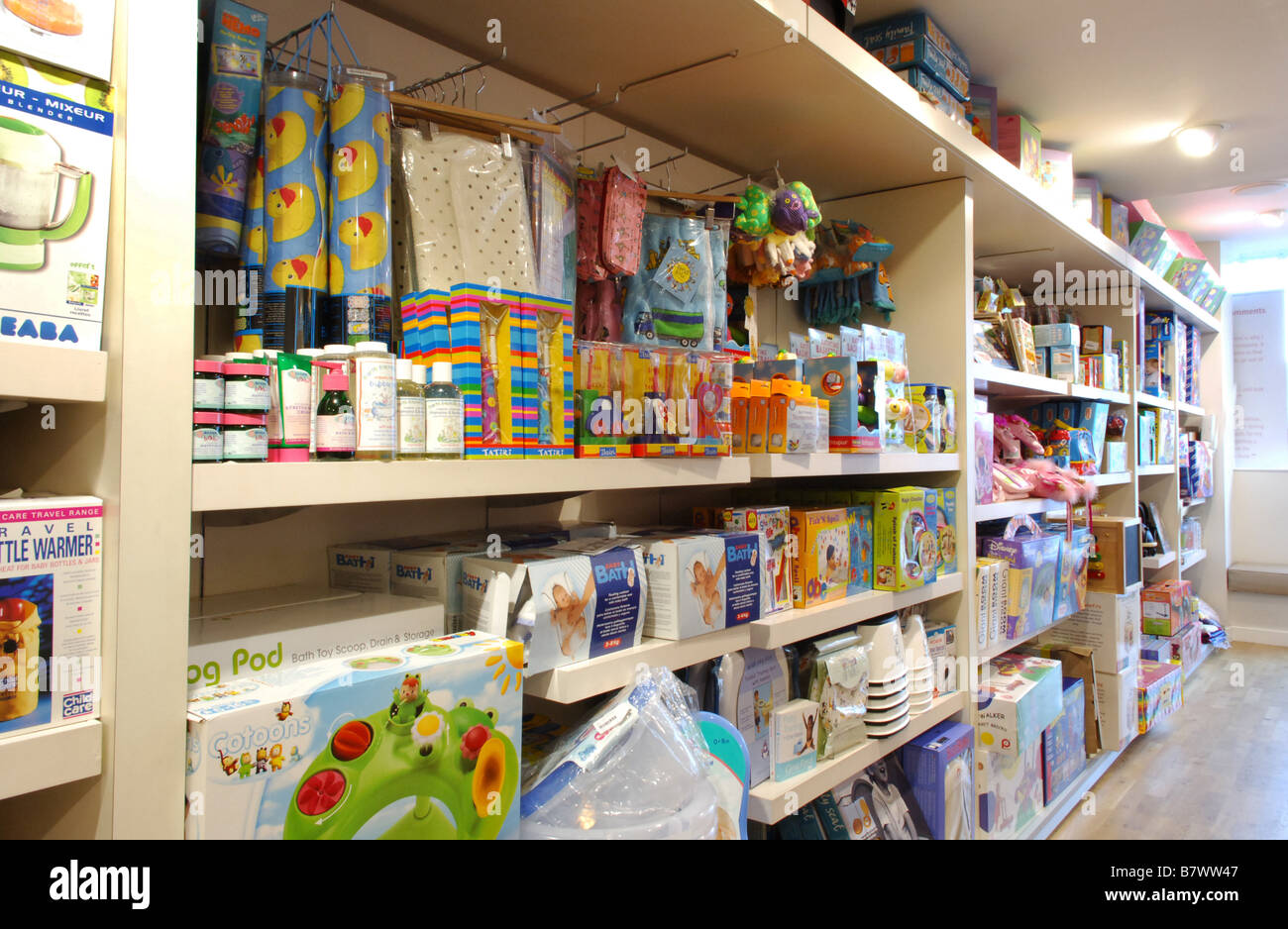 Shelves stocked with products for sale for pregnancy and babies and birth in Blooming Marvellous the maternity and baby shop. Stock Photo