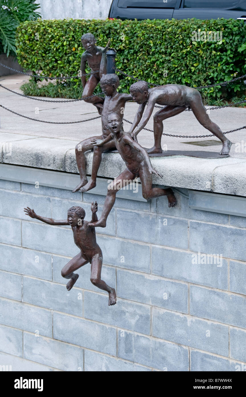 Three boys the first generation by Chong Fah Cheng sculptor statue sculpture Singapore river downtown Chinatown CBD Stock Photo