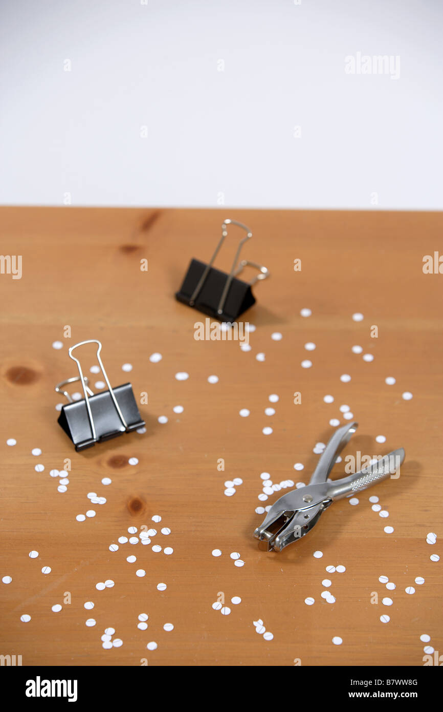 A hole punch and paper clips on a desk Stock Photo Alamy