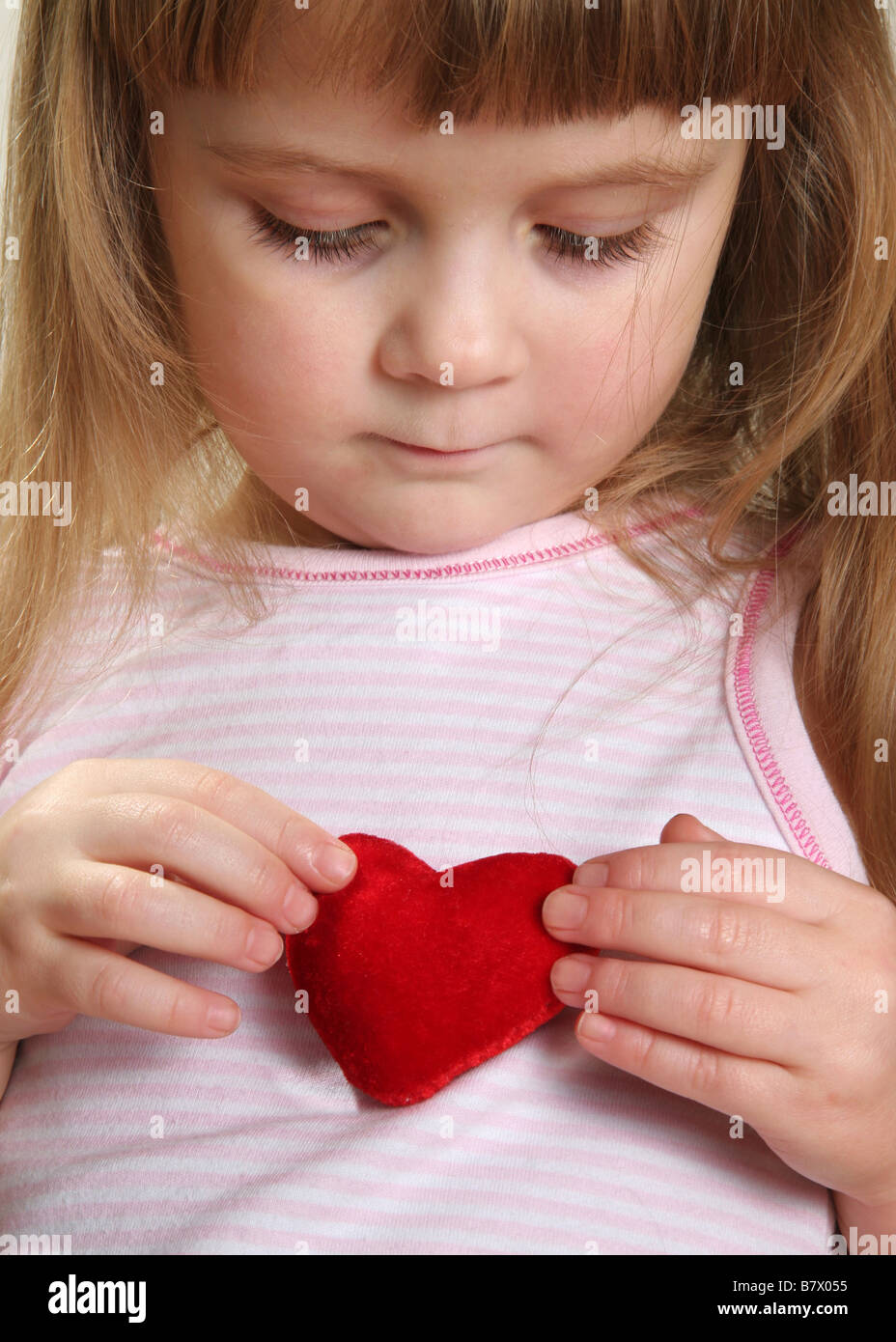 pretty child with red heart Stock Photo Alamy