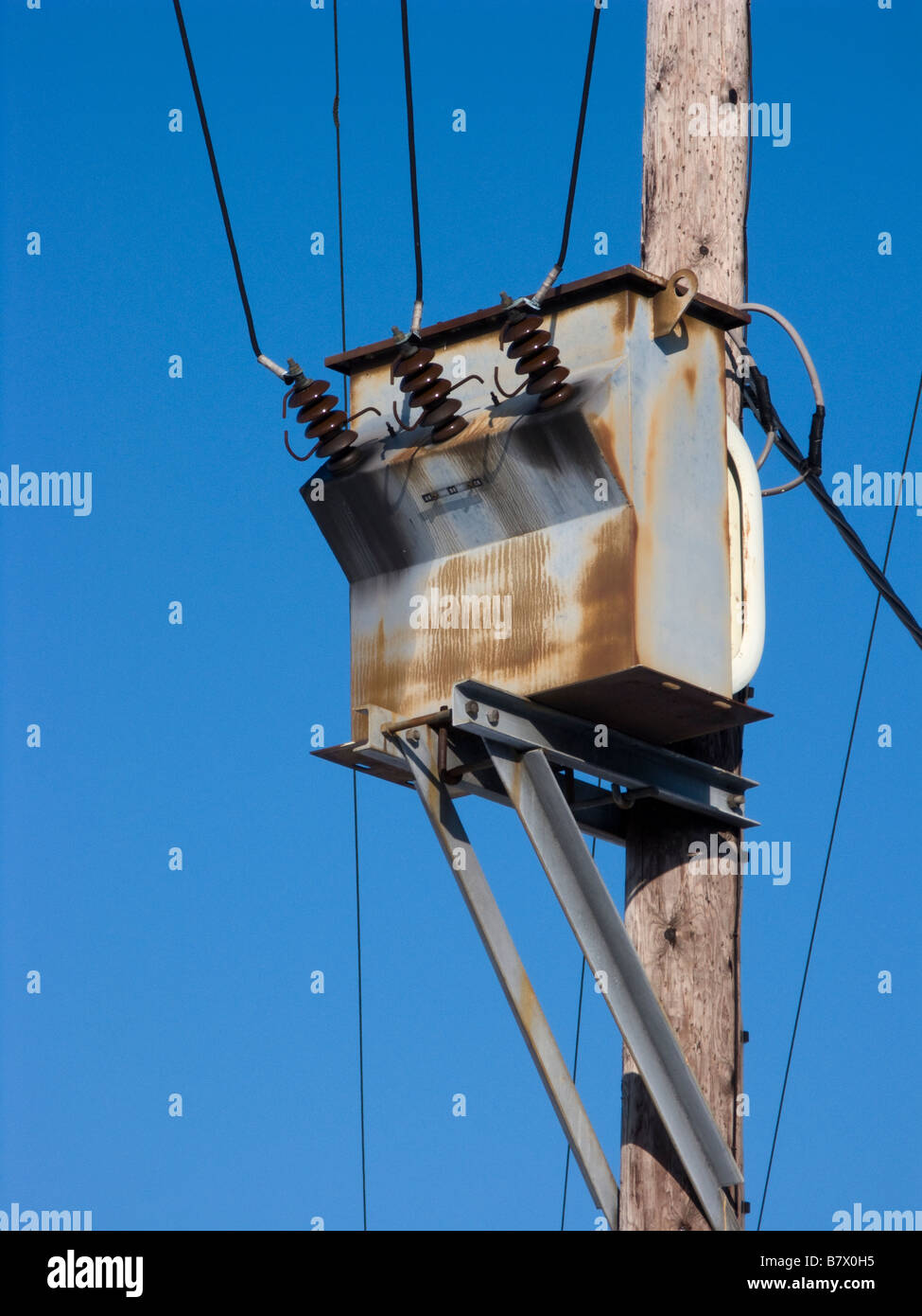 Electric pole against blue sky Stock Photo - Alamy