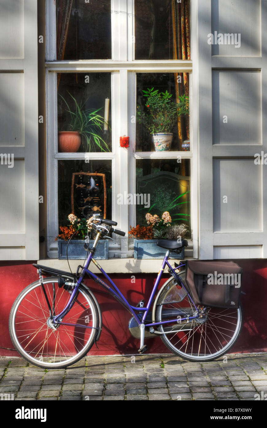 Bicycle parked against house central Bruges Belgium Stock Photo