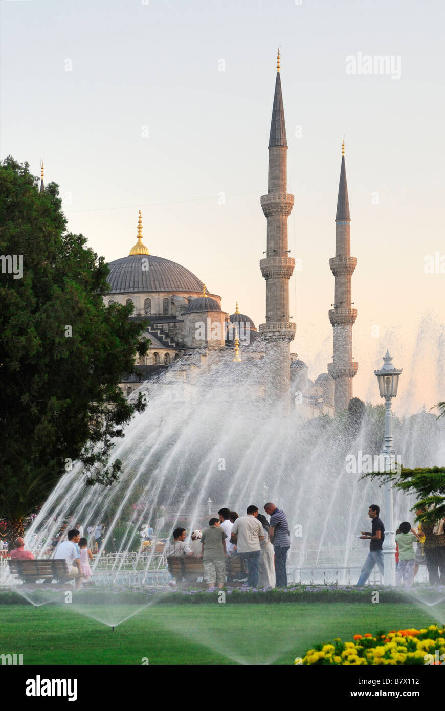 People relaxing at dusk outside the Blue Mosque (Sultan Ahmet Camii)  Istanbul turkey Stock Photo