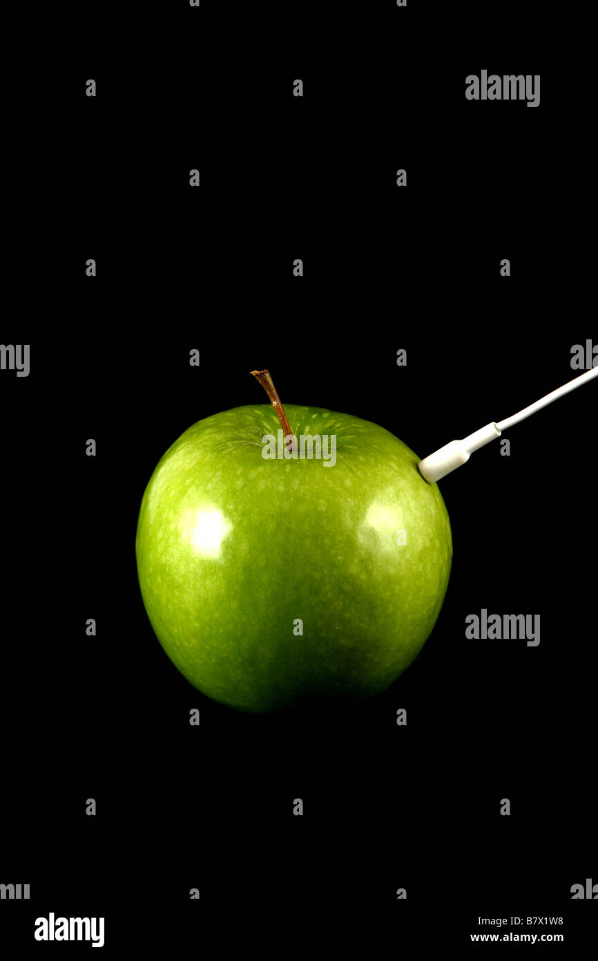 Apple with a white headphone cord Stock Photo Alamy