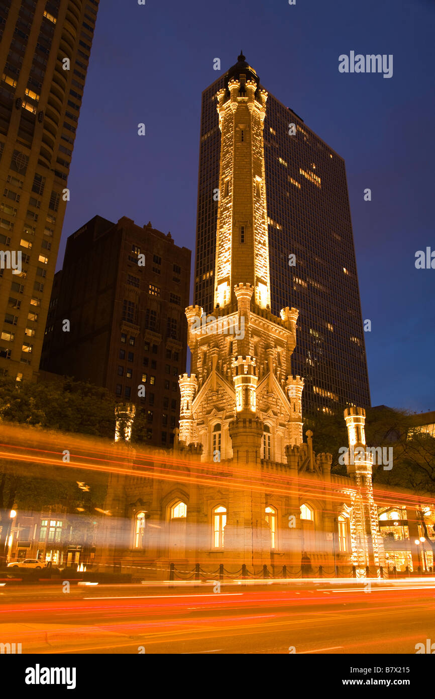 ILLINOIS Chicago Water Tower building on Michigan Avenue at dusk blurred lights of traffic on Magnificent Mile Stock Photo