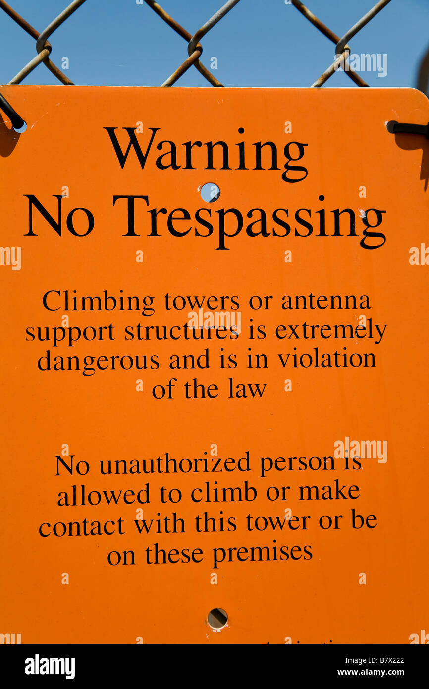 ILLINOIS DeKalb Orange warning sign posted on chain link fence trespassing  rules and regulations Stock Photo - Alamy