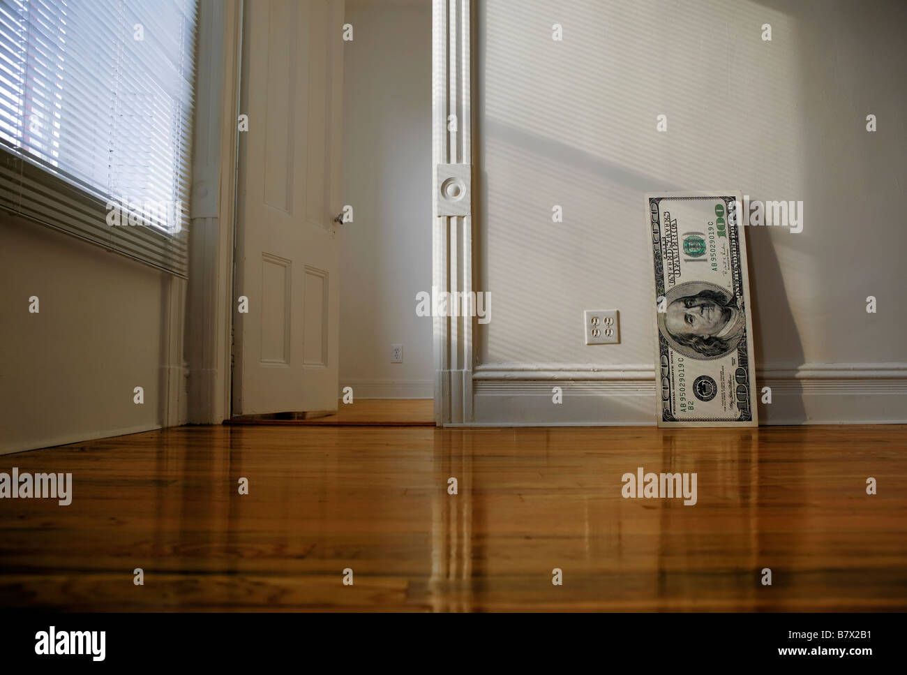 Huge size 100 dollar bill lean against wall Stock Photo