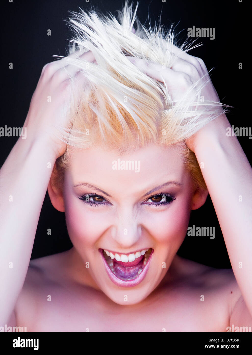 Young blond woman crazily screaming Stock Photo