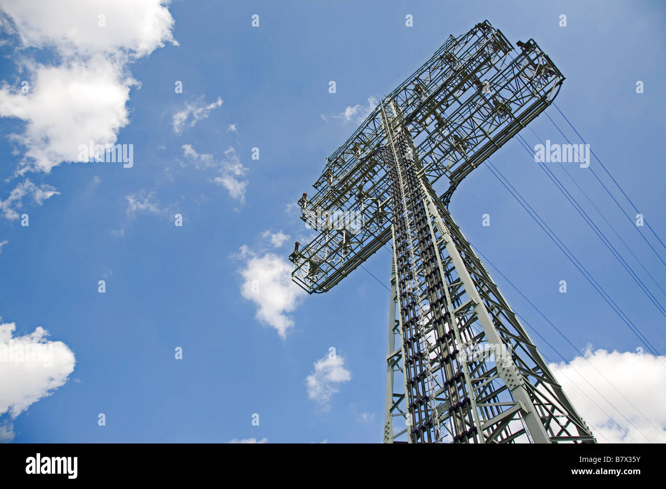 Electricty pylon against blue sky Stock Photo - Alamy
