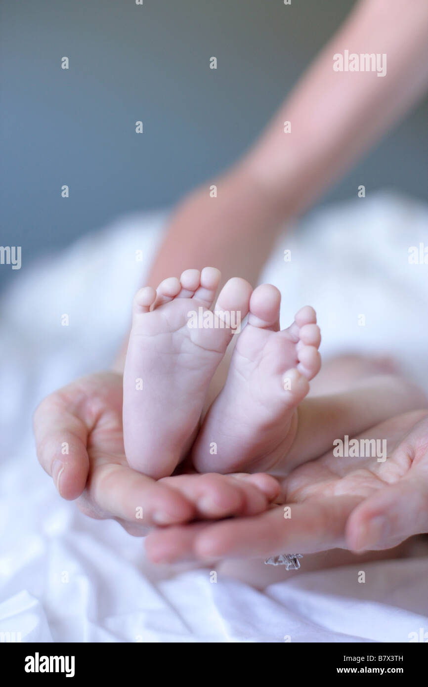 A Mother Holding Her Babies Feet Stock Photo Alamy