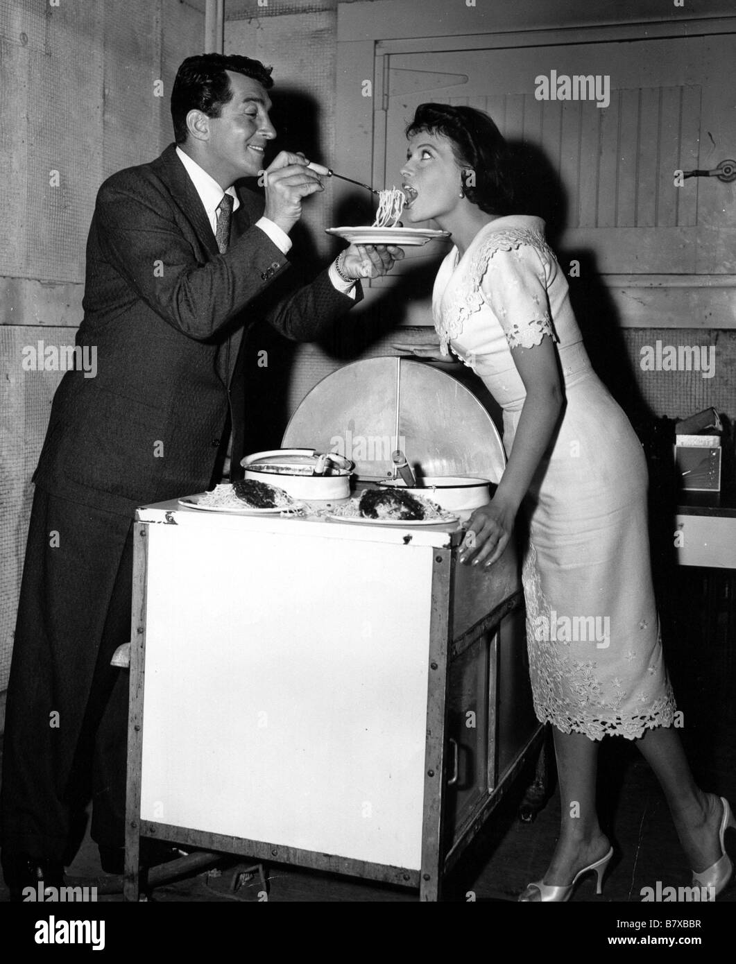 Dean Martin treats co-star Eva Bartok to his very special recipe of spaghetti. Stock Photo