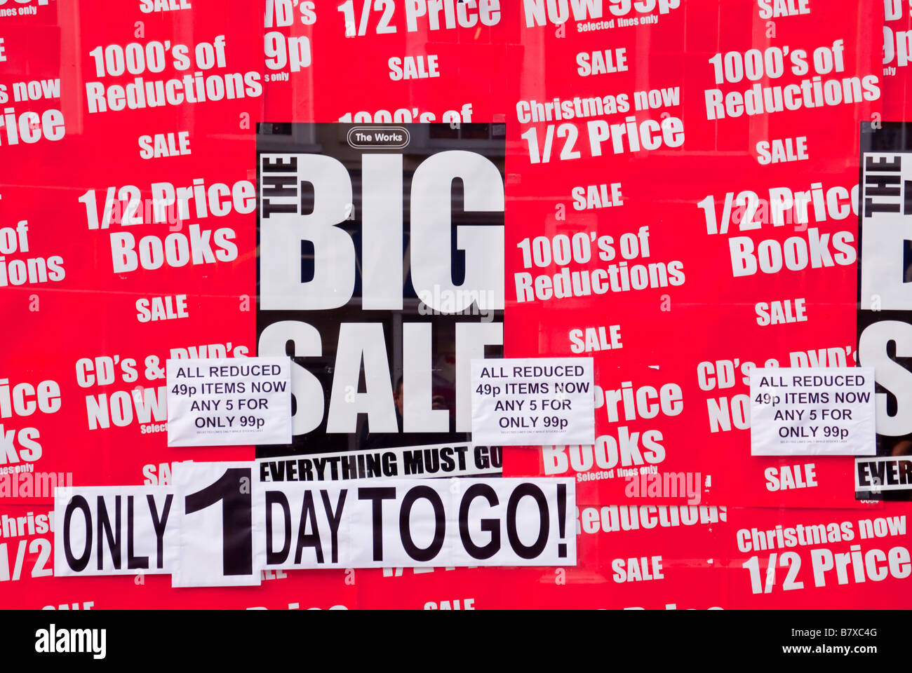 Book Sale advert in window of shop store selling half price cheap books