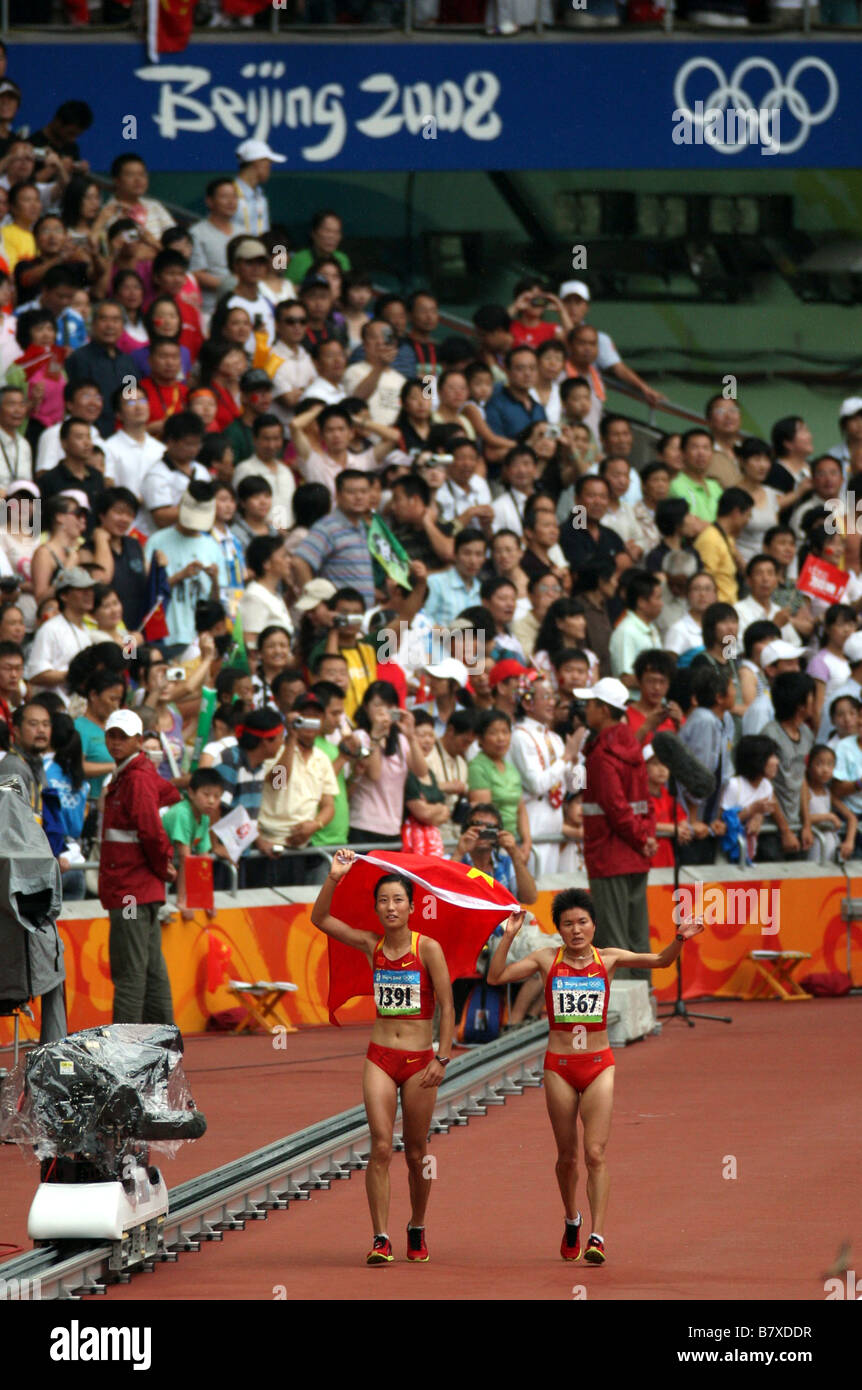 L to R ZHU Xiaolin ZHOU Chunxiu CHN AUGUST 17 2008 Athletics 4th place ZHU and 3rd place Zhou celeberate after the Womens Marat Stock Photo