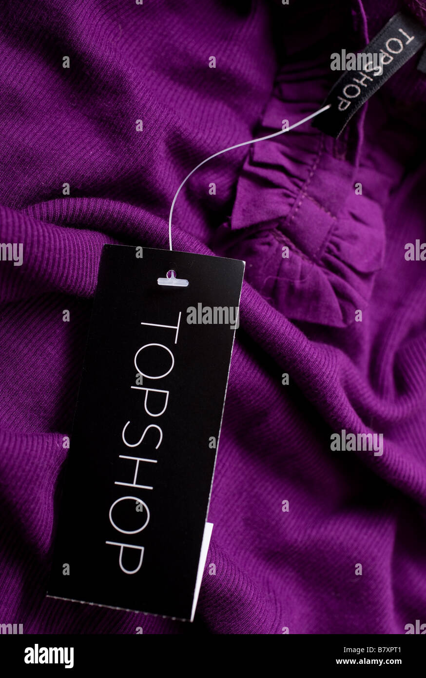 A purple garment showing the label Stock Photo Alamy