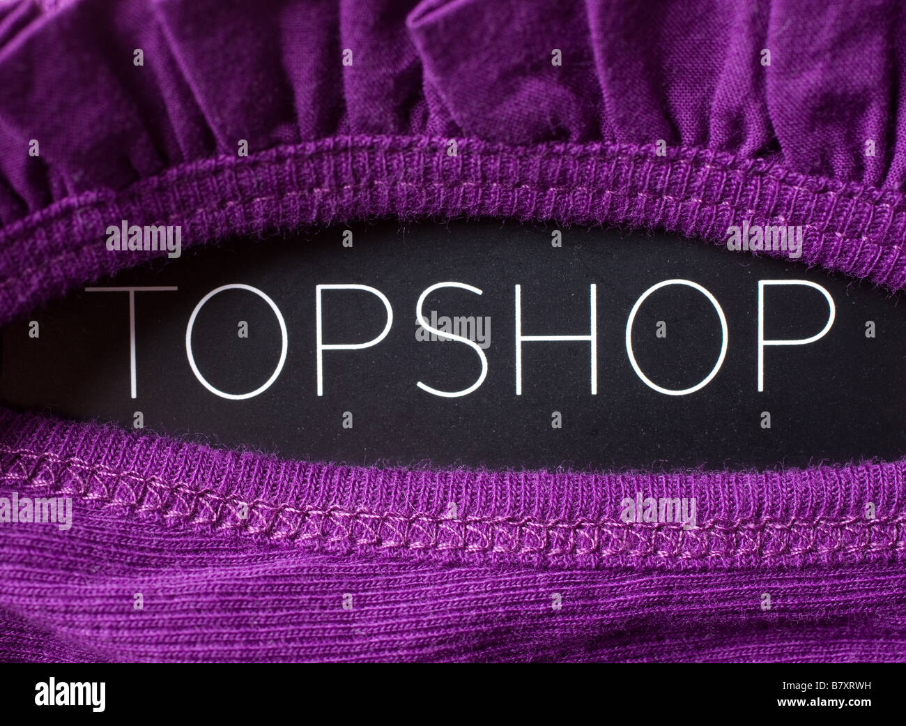 A purple garment showing the label Stock Photo Alamy