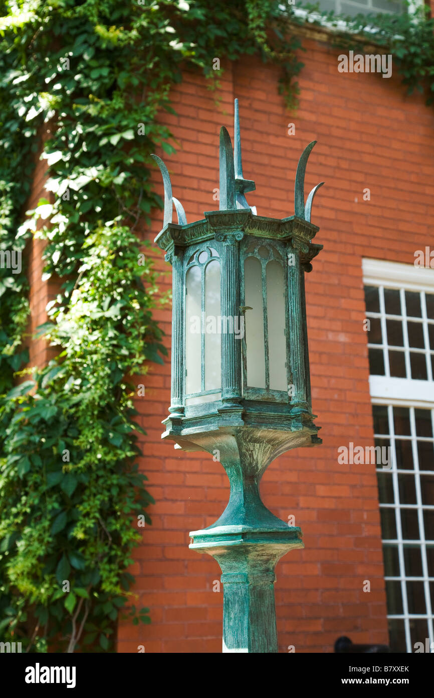 ILLINOIS DeKalb Light fixture outside Ellwood house and museum built for barbed wire millionaire ivy growing on brick building Stock Photo